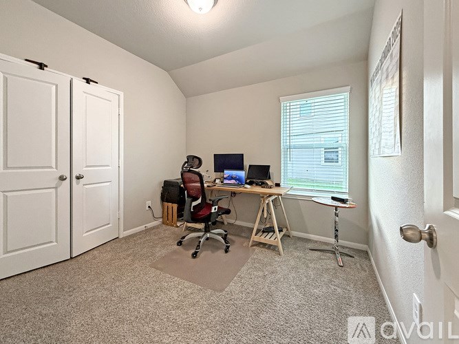 A room with a desk and a computer on it.