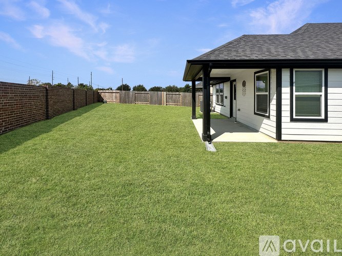 A house with a white fence and a green lawn.