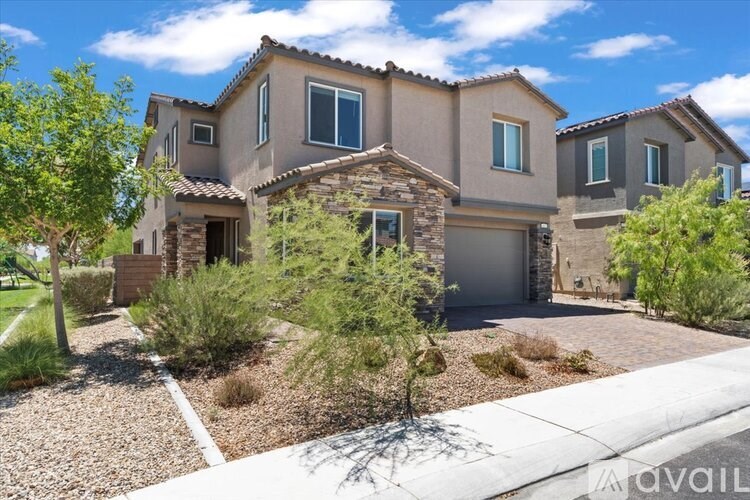 A house with a brown roof and a garage is surrounded by greenery.