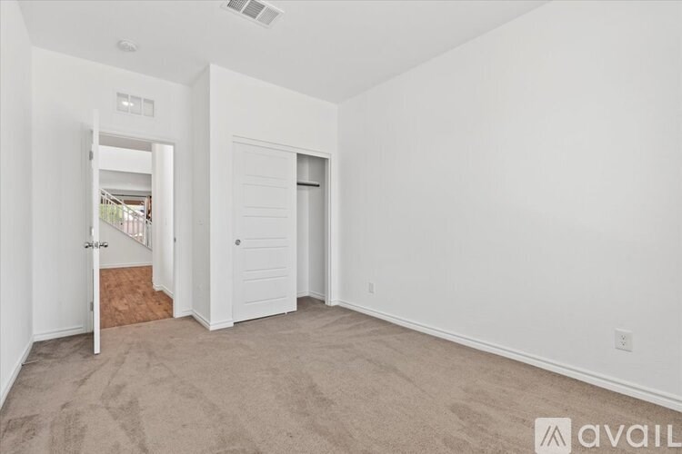 A room with a carpeted floor and white walls.