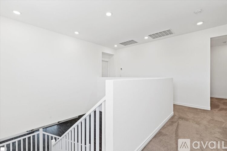 A room with a white wall and a carpeted floor.