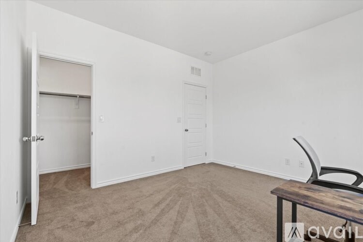 A room with a table and a chair in it.