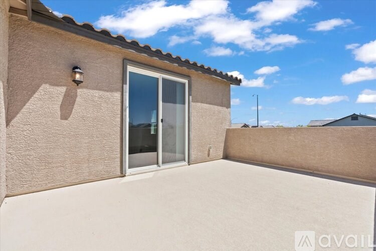 A house with a beige wall and a sliding glass door.