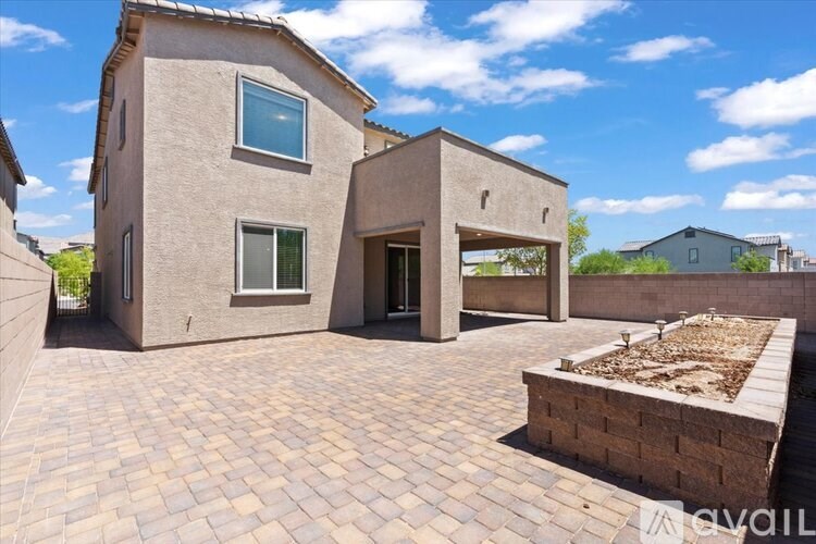 A house with a brick patio and a small garden area.