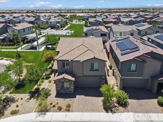 A bird's eye view of a neighborhood with houses and solar panels.