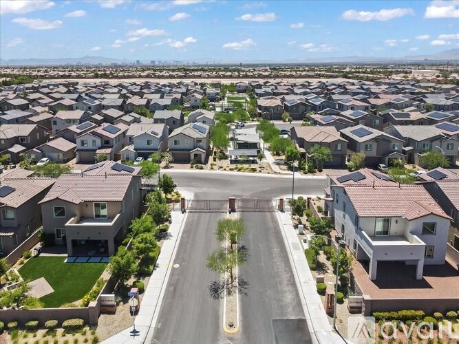 A suburban neighborhood with houses and a road in the foreground.
