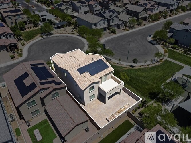 A modern house with a curved roof and solar panels on the roof.