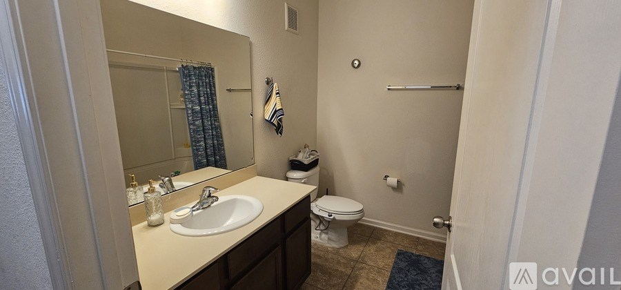 A bathroom with a sink, toilet, and shower.