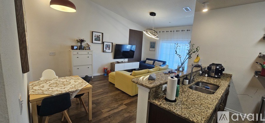 A kitchen with granite countertops and a dining table with chairs.