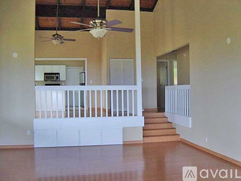 A living room with a staircase leading to the upper floor.