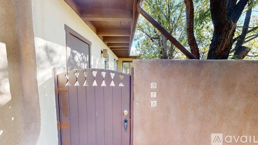 A brown door with a keypad and a key hole is seen.