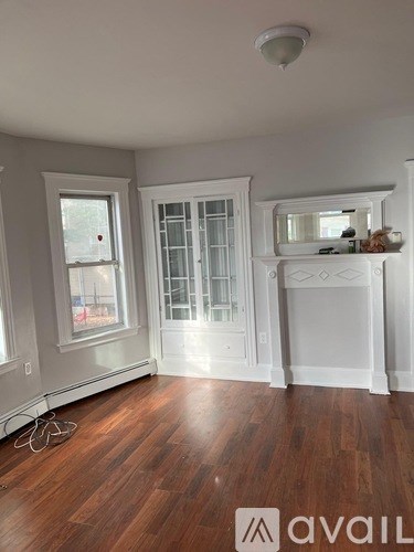 A room with wood floors and white walls.