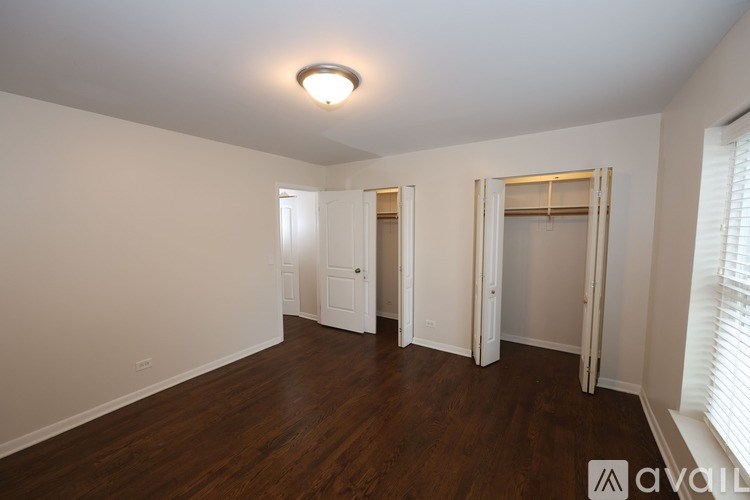 A room with wooden floors and white walls.