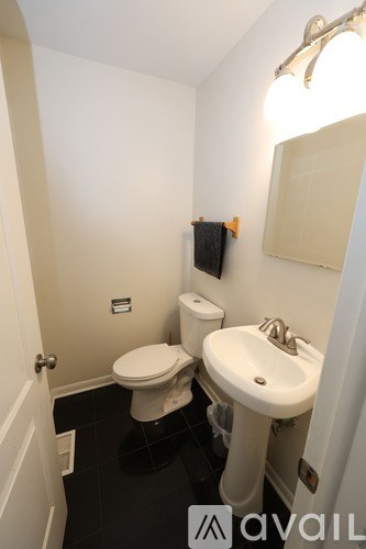 A small bathroom with a toilet, sink and mirror.