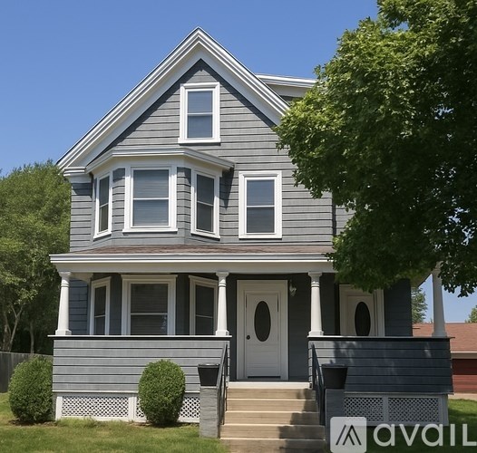 A two-story house with a grey exterior and white trim.