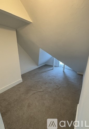 A room with a carpeted floor and white walls.