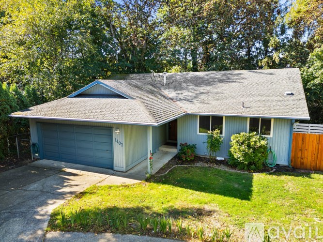 A house with a grey roof and a blue garage door.