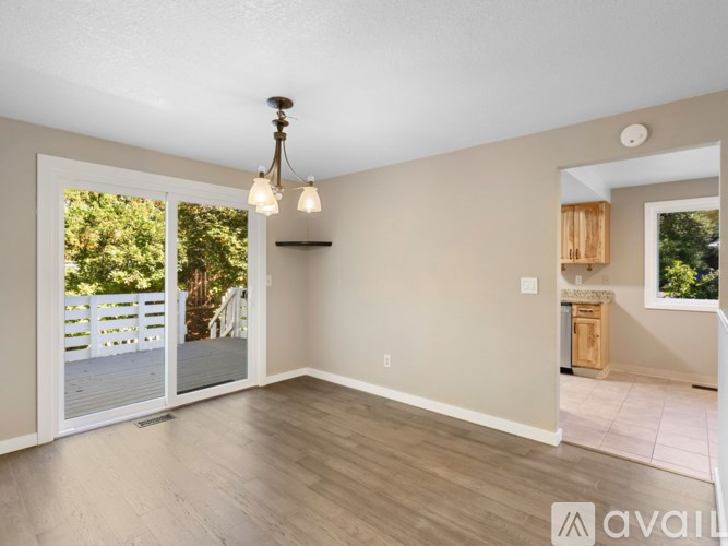 A room with a sliding glass door leading to a deck.