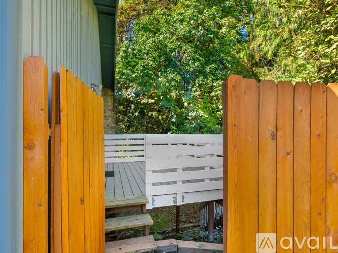 A wooden fence with a white bench in the background.
