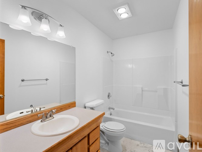 A bathroom with a sink, toilet, and bathtub.