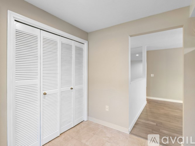 Closed white doors in a room with a tan wall.