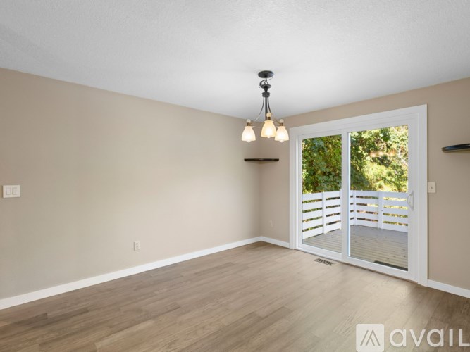 A room with a sliding door leading to a deck.