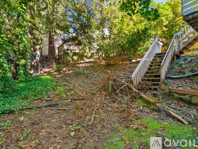A backyard with a staircase and a fence.