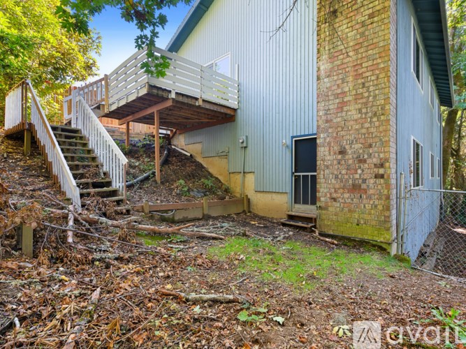 A backyard with a staircase and a building.
