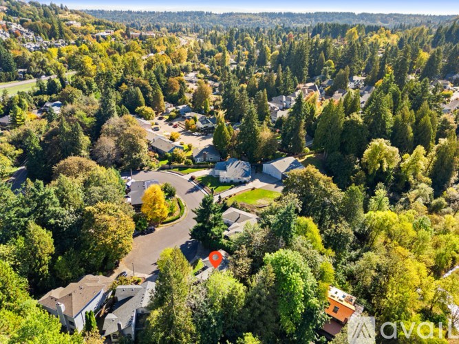 A bird's eye view of a residential area surrounded by trees.