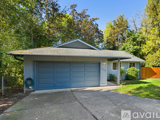 A house with a blue garage door is for sale.