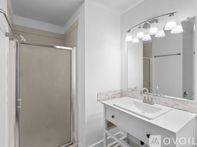 A bathroom with a white sink and a mirror.