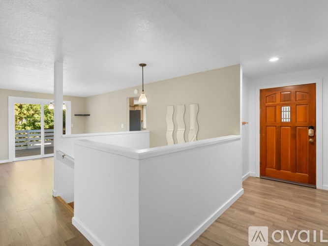 A white reception desk with a brown door in a room.