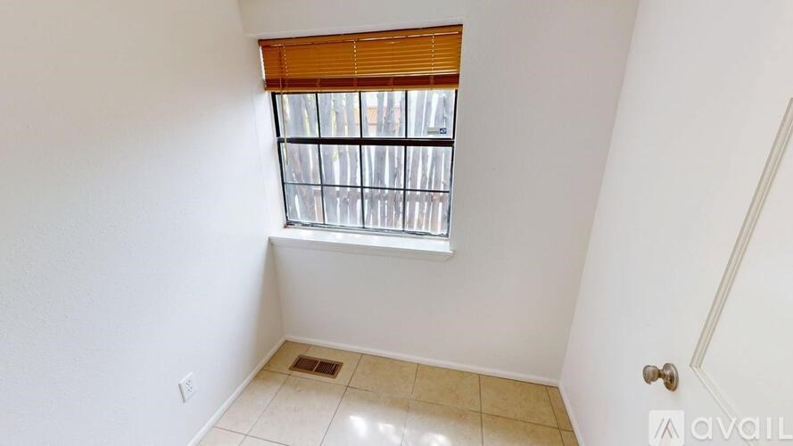 A room with a window and a door.