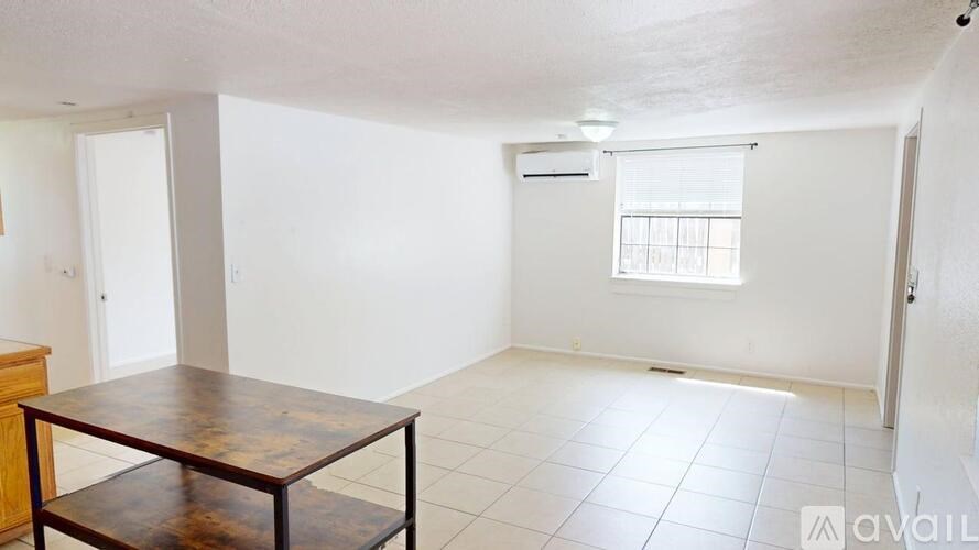 A room with a table and a window.