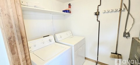 A small laundry room with a washer and dryer.