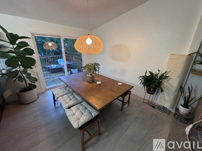A living room with a wooden table and a bench.