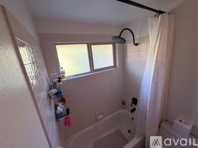 A small bathroom with a tub, toilet, and sink.