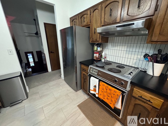 A kitchen with a refrigerator, stove, and oven.