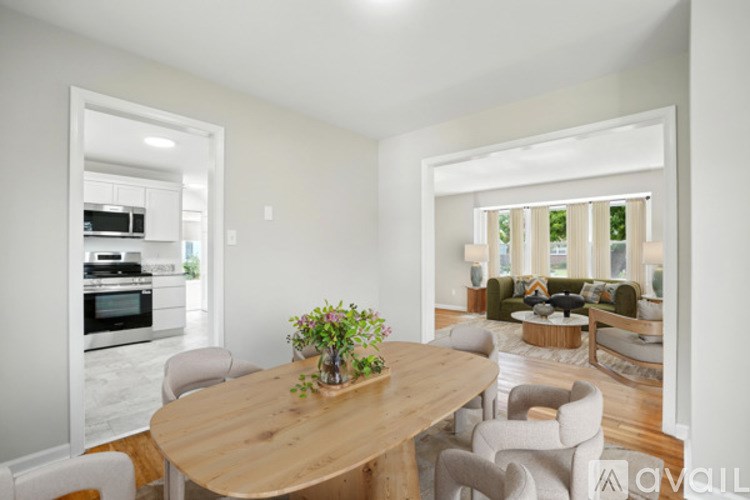 A dining room with a wooden table and chairs.