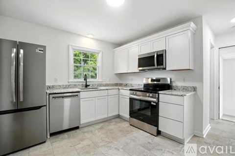 A kitchen with white cabinets and stainless steel appliances.