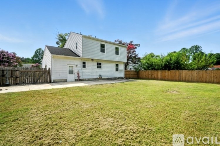 A white house with a fence and a yard.