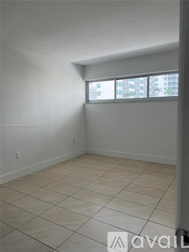 A room with tiled flooring and a window.
