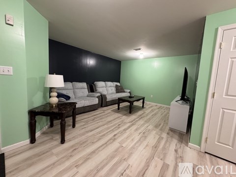 A living room with a grey sofa and a black coffee table.