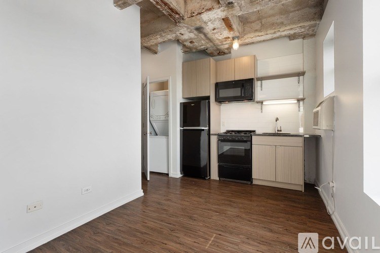 A kitchen with wooden floors and white walls.