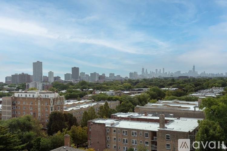 A cityscape with buildings and trees in the foreground.