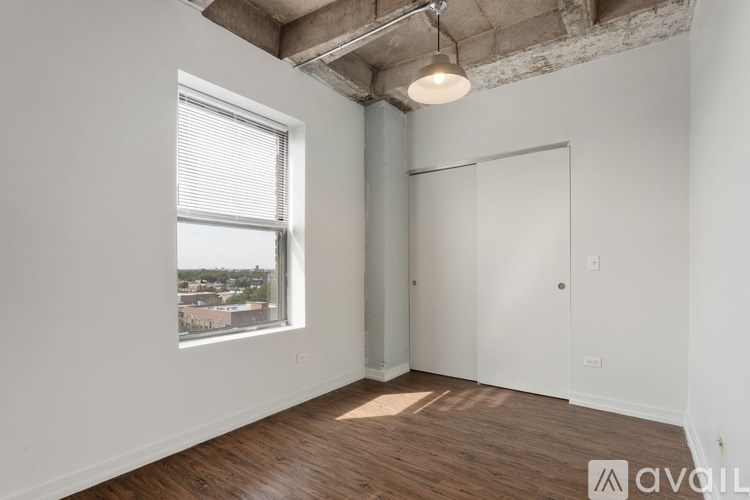 A room with a window and a door is available for rent.