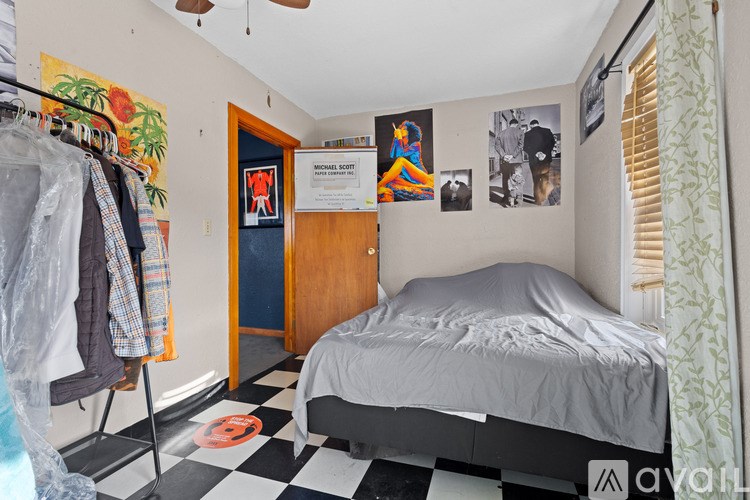 A bedroom with a bed, a wardrobe, and a ceiling fan.