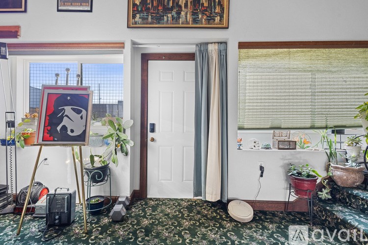 A room with a Star Wars poster on a easel.