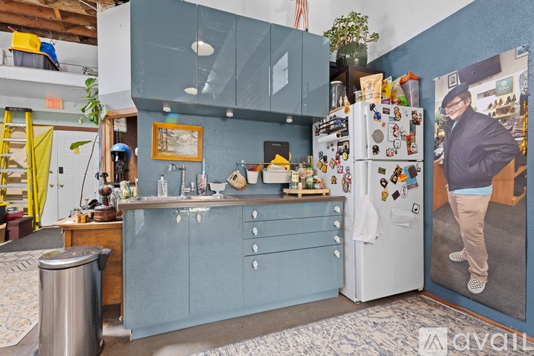A kitchen with a blue cabinet and a white fridge.