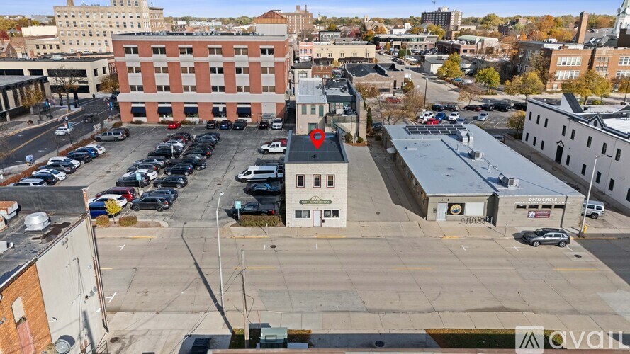 A parking lot with cars and buildings in the background.